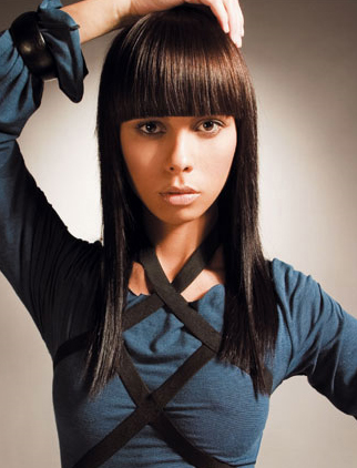 Heavy Blunt bangs with silky straight hairstyle that is modern and edgy.