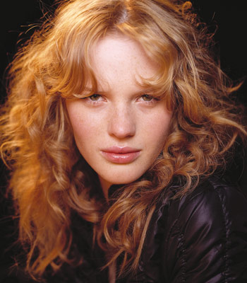 Naturally red hair with soft big curls look great with layers cut into the 