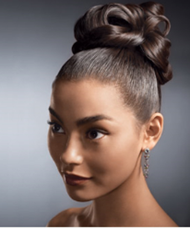 This high bow bun wedding updo is ideal for girls with thin hair as it is a