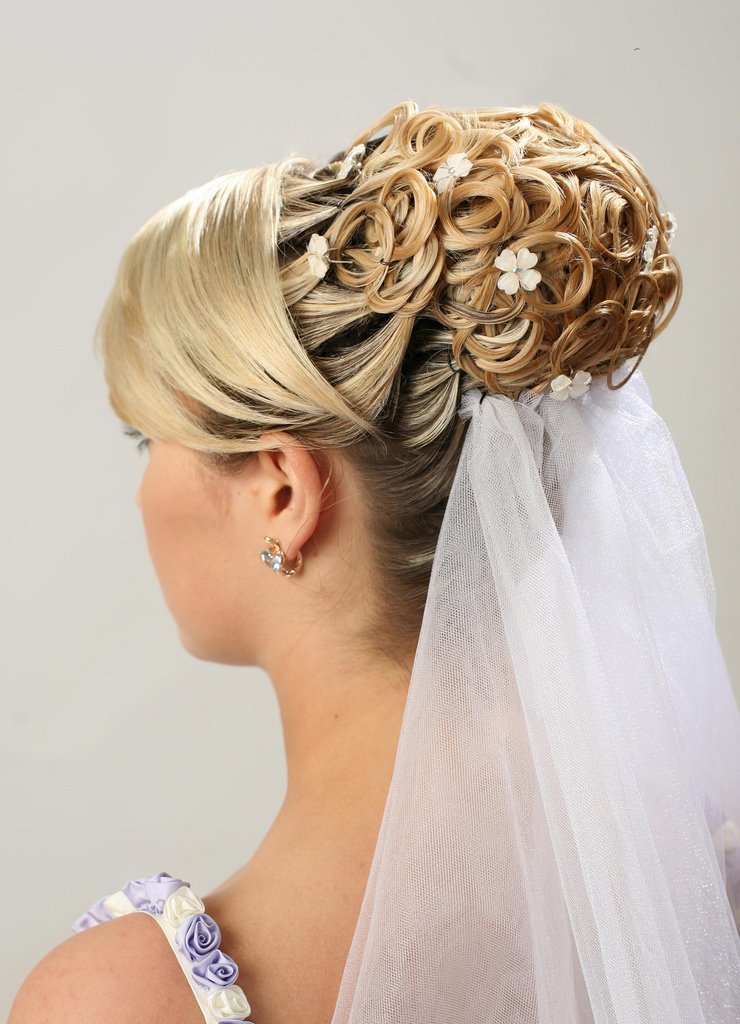 Bridal wedding veil coming out of elaborate fancy bride updo