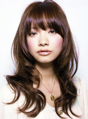 Layered hair with silky heavy bangs .