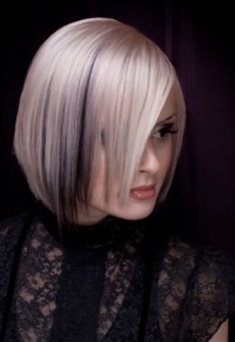 Medium length bob haircut in platinum blonde with black underneath.