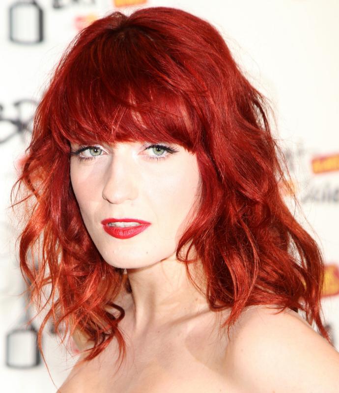 Florence Welch with bright fire engine red hair