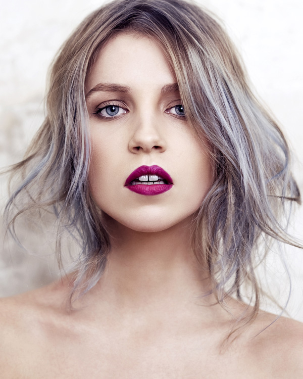 Asymmetrical haircut in ash blonde with lilac tones. 