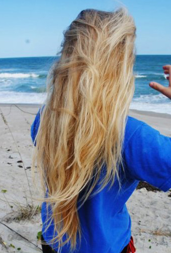 girl with long blonde hair at the beach