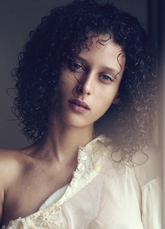 Ludmilla Dom Perignon shoulder length curly hair