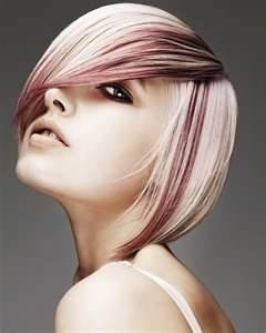 Short asymmetrical haircut in icy white blonde with dark red streaks